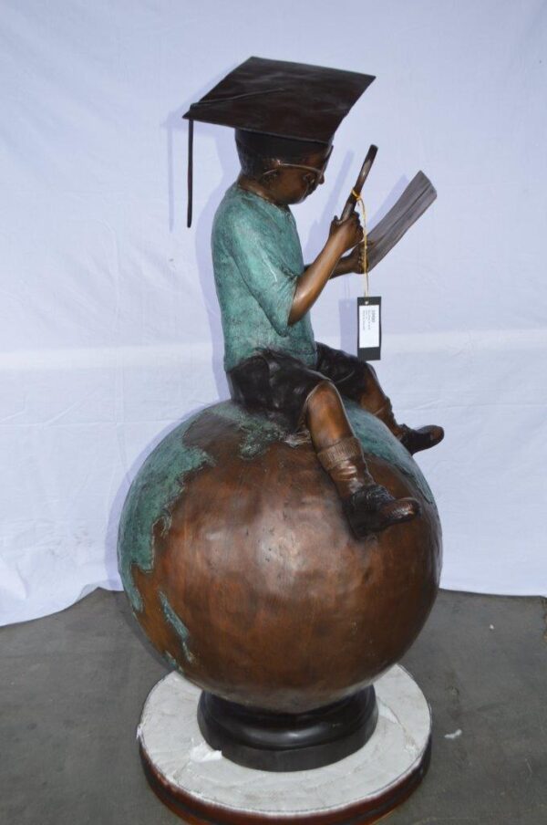 Student learning on top of world bronze statue -  Size: 28"L x 24"W x 52"H. - Image 4