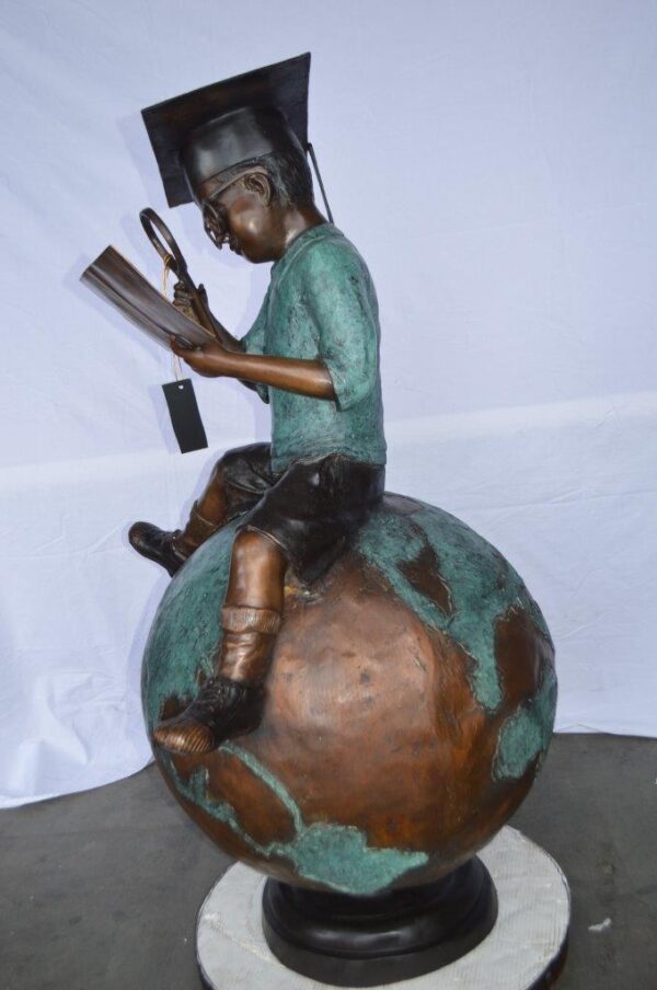Student learning on top of world bronze statue -  Size: 28"L x 24"W x 52"H. - Image 9