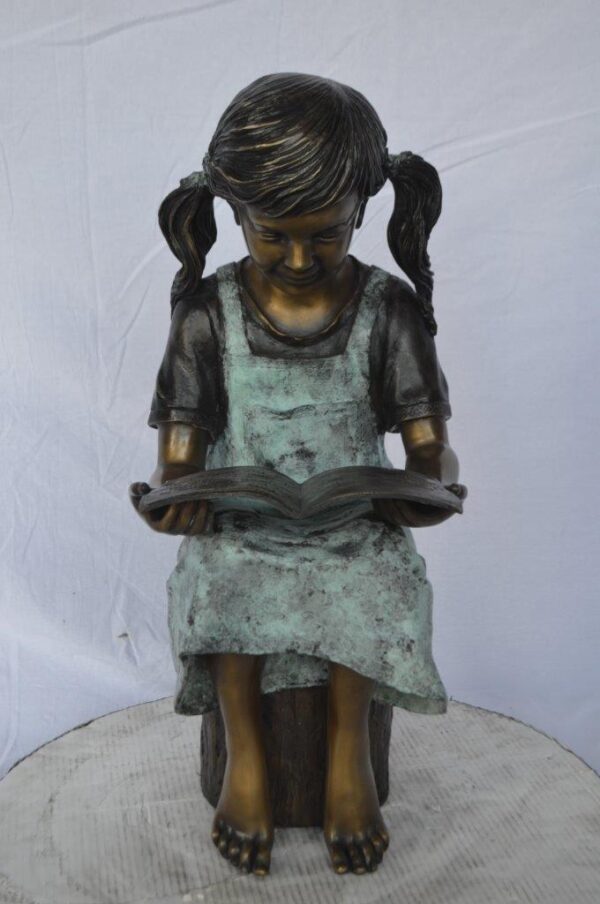 Young girl sitting and reading book bronze statue -  Size: 16"L x 12"W x 27"H. - Image 2