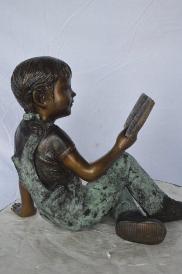 Young girl laying and reading book bronze statue -  Size: 18"L x 9"W x 16"H. - Image 5