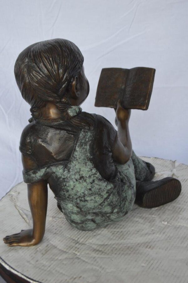 Young girl laying and reading book bronze statue -  Size: 18"L x 9"W x 16"H. - Image 6