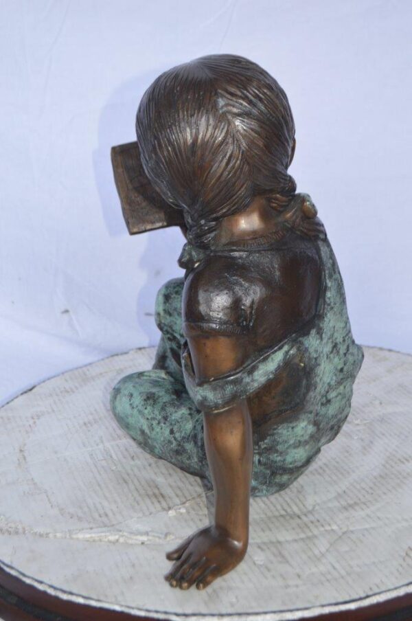 Young girl laying and reading book bronze statue -  Size: 18"L x 9"W x 16"H. - Image 7
