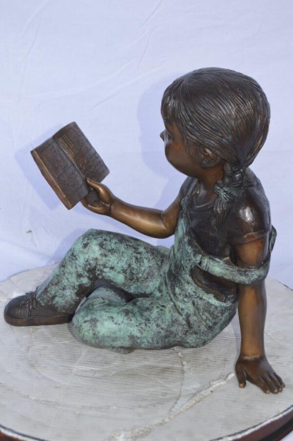Young girl laying and reading book bronze statue -  Size: 18"L x 9"W x 16"H. - Image 8