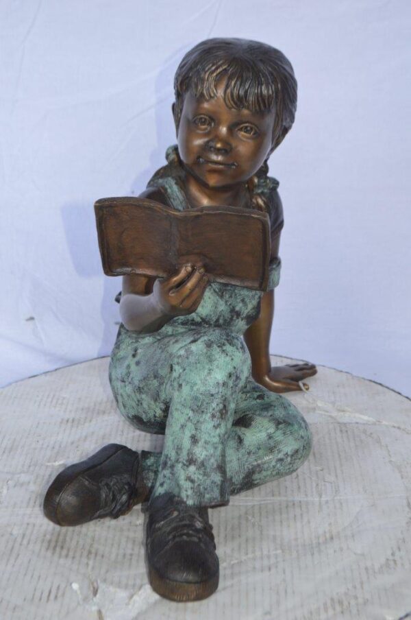 Young girl laying and reading book bronze statue -  Size: 18"L x 9"W x 16"H. - Image 10