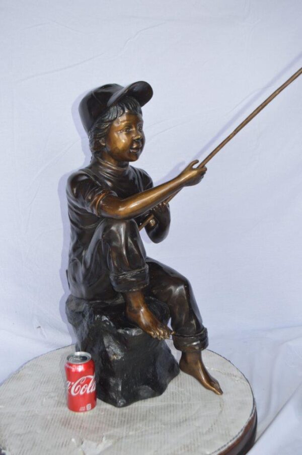 Young Boy sitting on a rock fishing bronze statue -  Size: 31"L x 9"W x 33"H. - Image 4