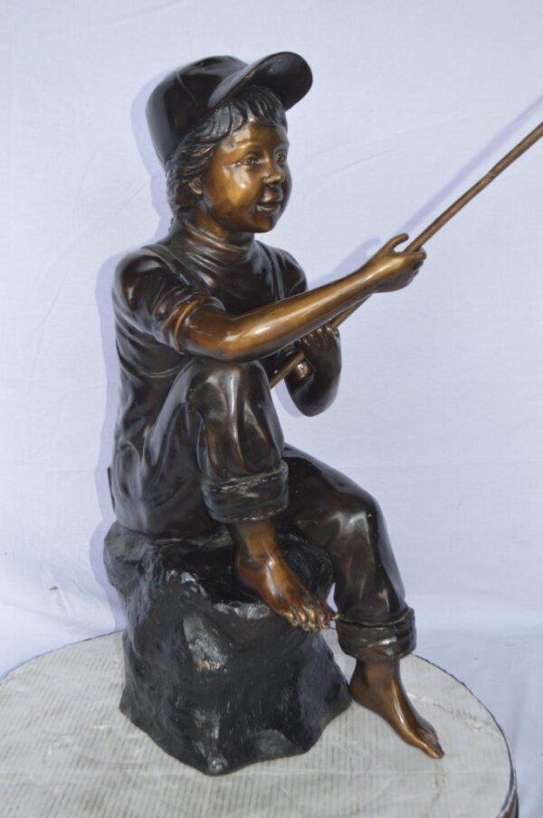Young Boy sitting on a rock fishing bronze statue -  Size: 31"L x 9"W x 33"H. - Image 5
