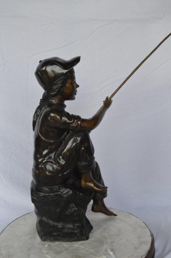 Young Boy sitting on a rock fishing bronze statue -  Size: 31"L x 9"W x 33"H. - Image 6
