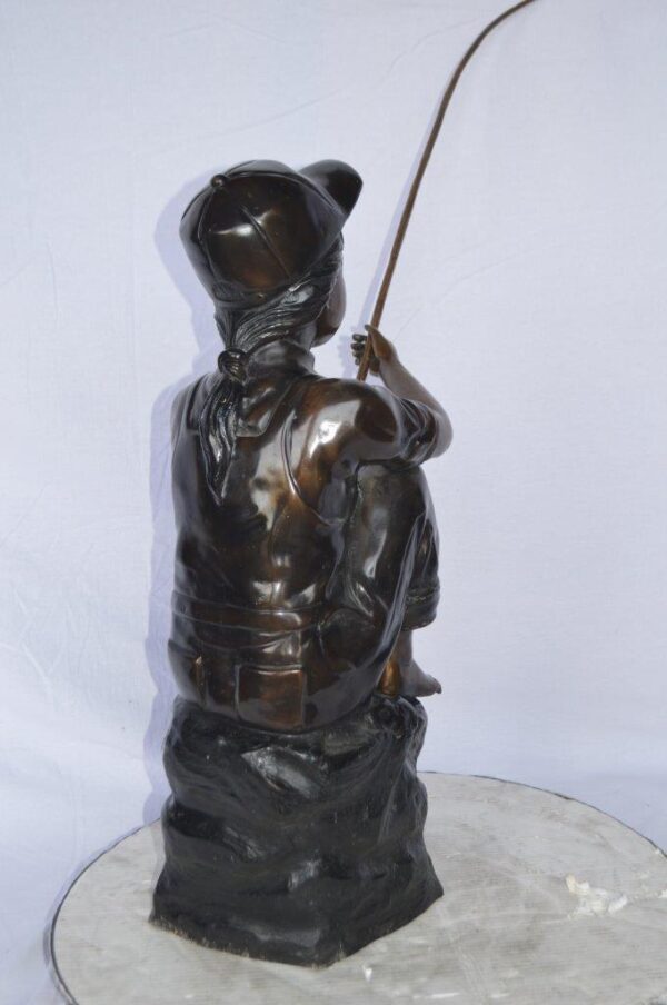 Young Boy sitting on a rock fishing bronze statue -  Size: 31"L x 9"W x 33"H. - Image 7