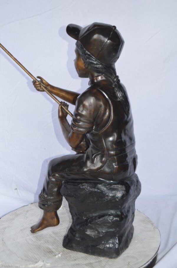 Young Boy sitting on a rock fishing bronze statue -  Size: 31"L x 9"W x 33"H. - Image 9