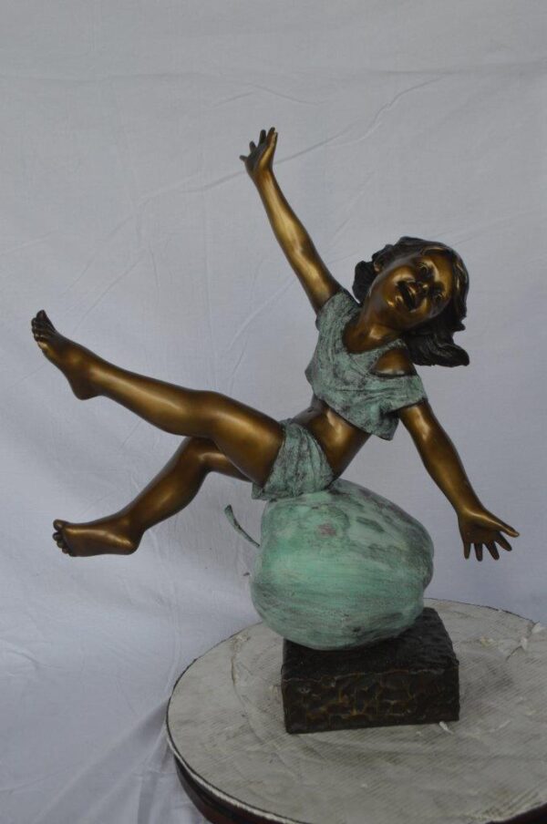 Girl having fun on apple bronze statue -  Size: 22"L x 9"W x 31"H. - Image 2