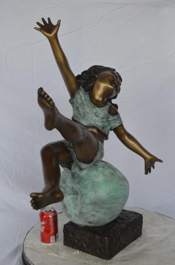 Girl having fun on apple bronze statue -  Size: 22"L x 9"W x 31"H. - Image 4