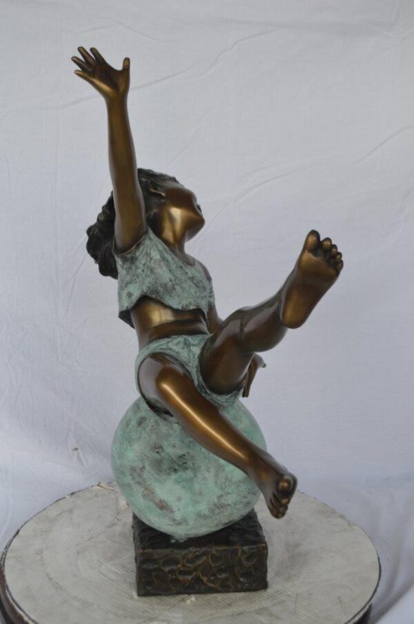 Girl having fun on apple bronze statue -  Size: 22"L x 9"W x 31"H. - Image 5
