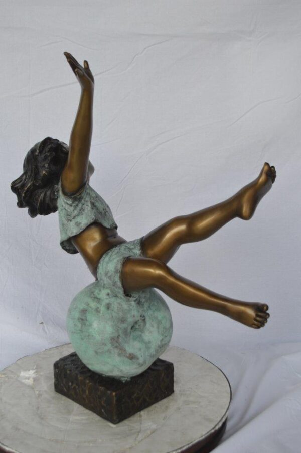 Girl having fun on apple bronze statue -  Size: 22"L x 9"W x 31"H. - Image 6