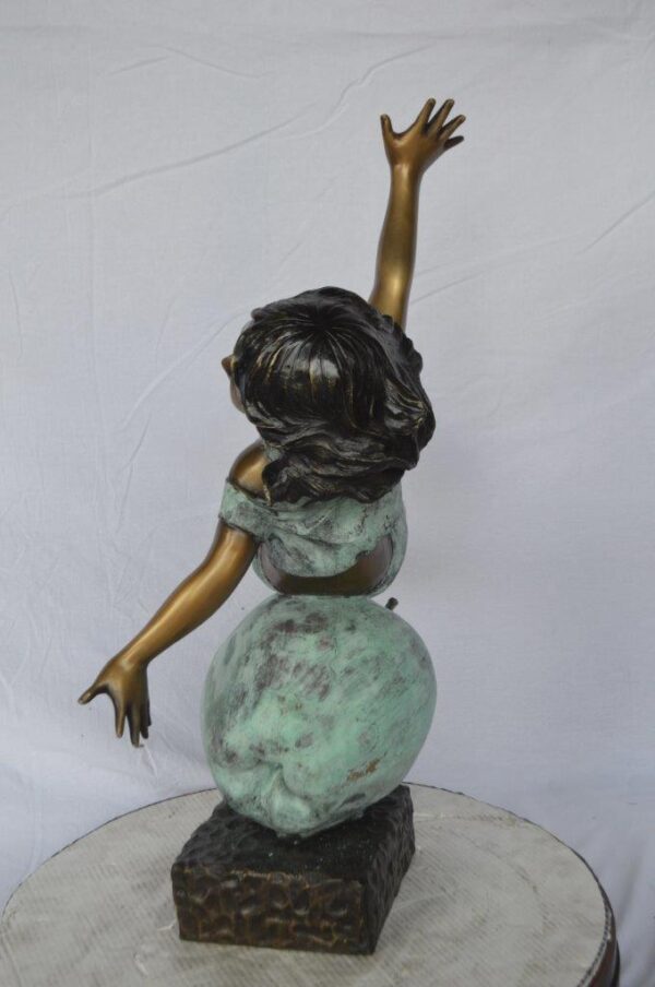 Girl having fun on apple bronze statue -  Size: 22"L x 9"W x 31"H. - Image 8