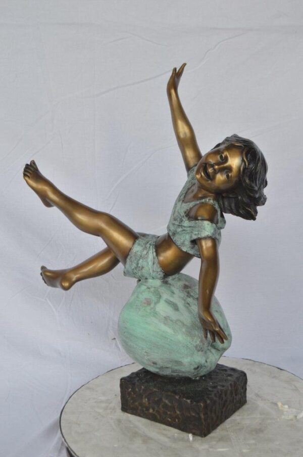 Girl having fun on apple bronze statue -  Size: 22"L x 9"W x 31"H. - Image 10