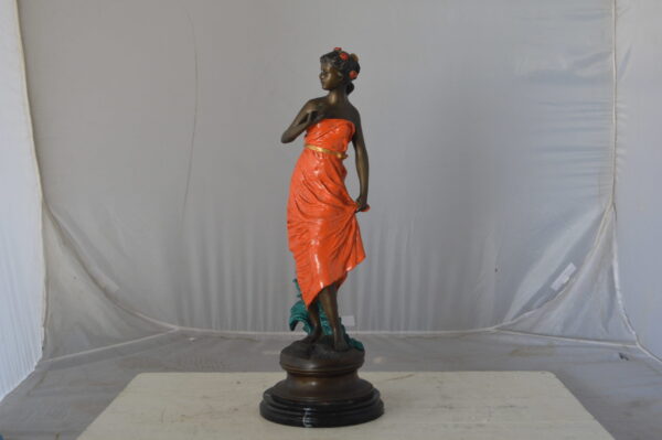 Young lady in orange bronze statue - Size: 7"L x 26"W x 25"H. - Image 3