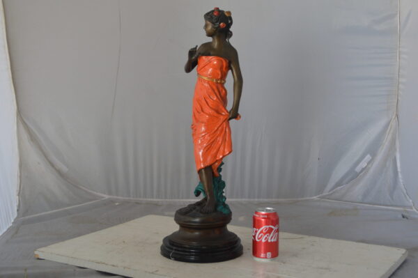 Young lady in orange bronze statue - Size: 7"L x 26"W x 25"H. - Image 4