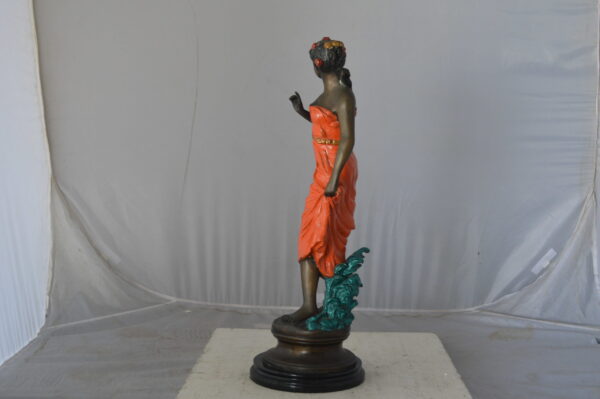 Young lady in orange bronze statue - Size: 7"L x 26"W x 25"H. - Image 6
