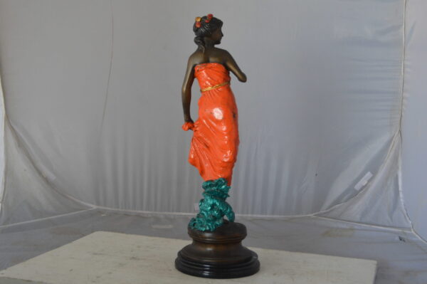 Young lady in orange bronze statue - Size: 7"L x 26"W x 25"H. - Image 9