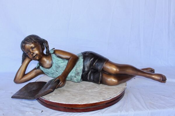 Peaceful young girl enjoying a read bronze statue -  Size: 40"L x 17"W x 13"H. - Image 4
