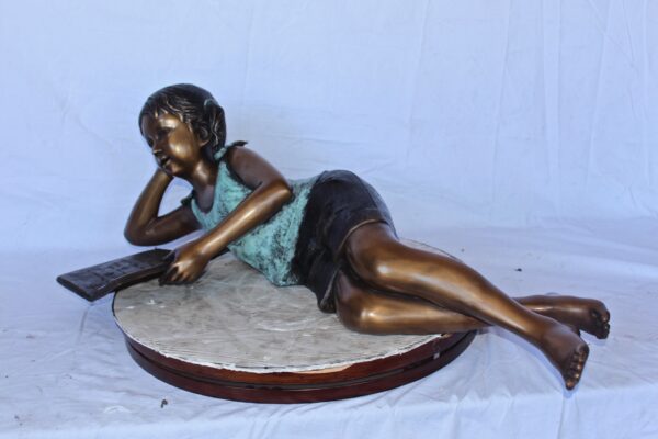 Peaceful young girl enjoying a read bronze statue -  Size: 40"L x 17"W x 13"H. - Image 5