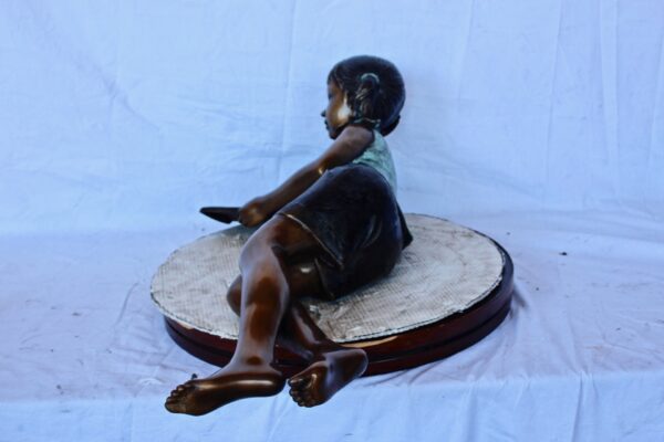 Peaceful young girl enjoying a read bronze statue -  Size: 40"L x 17"W x 13"H. - Image 6