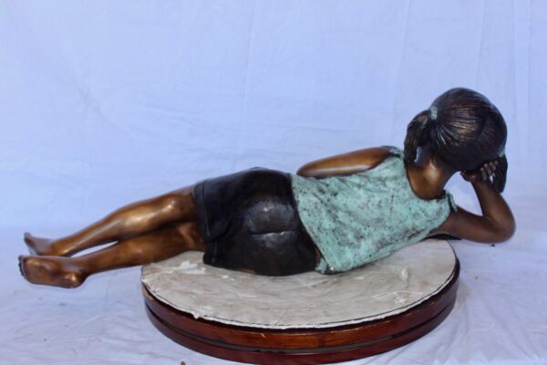 Peaceful young girl enjoying a read bronze statue -  Size: 40"L x 17"W x 13"H. - Image 7