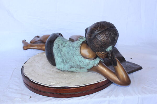 Peaceful young girl enjoying a read bronze statue -  Size: 40"L x 17"W x 13"H. - Image 8