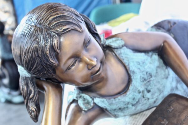 Peaceful young girl enjoying a read bronze statue -  Size: 40"L x 17"W x 13"H. - Image 12