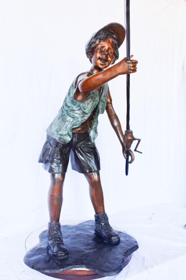 A young boy and his fishing journey bronze statue -  Size: 24"L x 26"W x 47"H. - Image 4