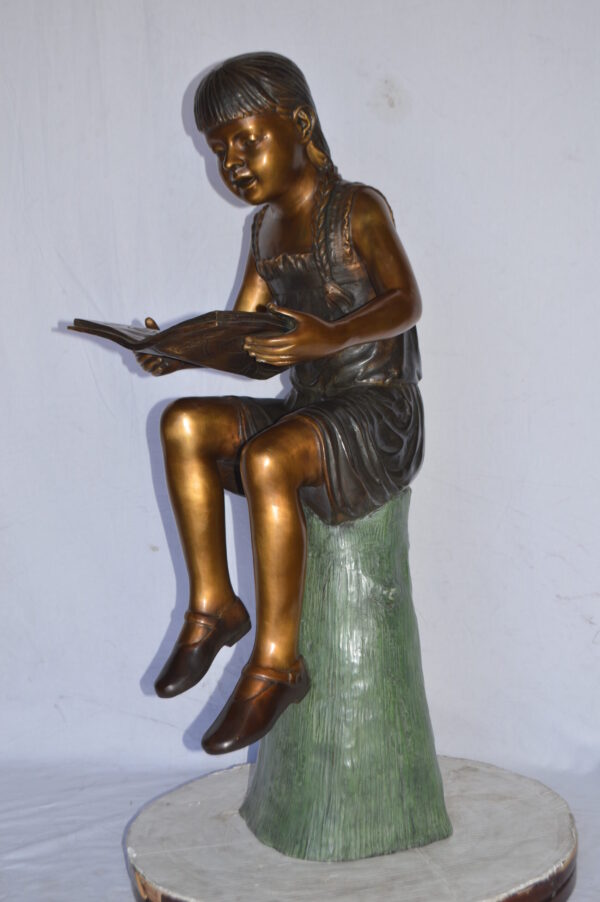 Girl Sitting on a Tree Stump, Reading Bronze Statue - Size: 15"L x 20"W x 22"H. - Image 4