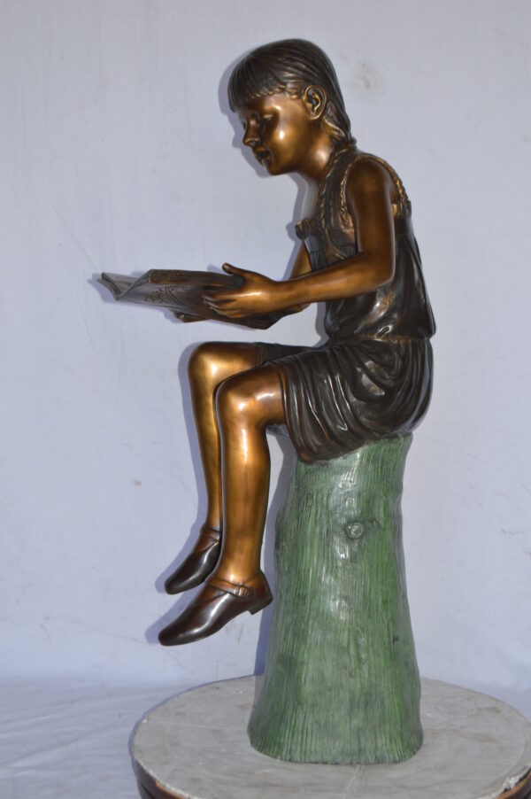 Girl Sitting on a Tree Stump, Reading Bronze Statue - Size: 15"L x 20"W x 22"H. - Image 5