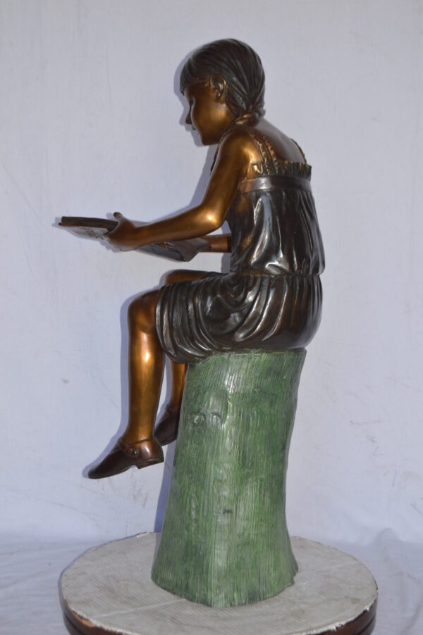Girl Sitting on a Tree Stump, Reading Bronze Statue - Size: 15"L x 20"W x 22"H. - Image 6