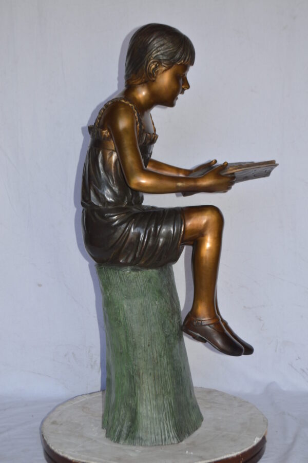 Girl Sitting on a Tree Stump, Reading Bronze Statue - Size: 15"L x 20"W x 22"H. - Image 9