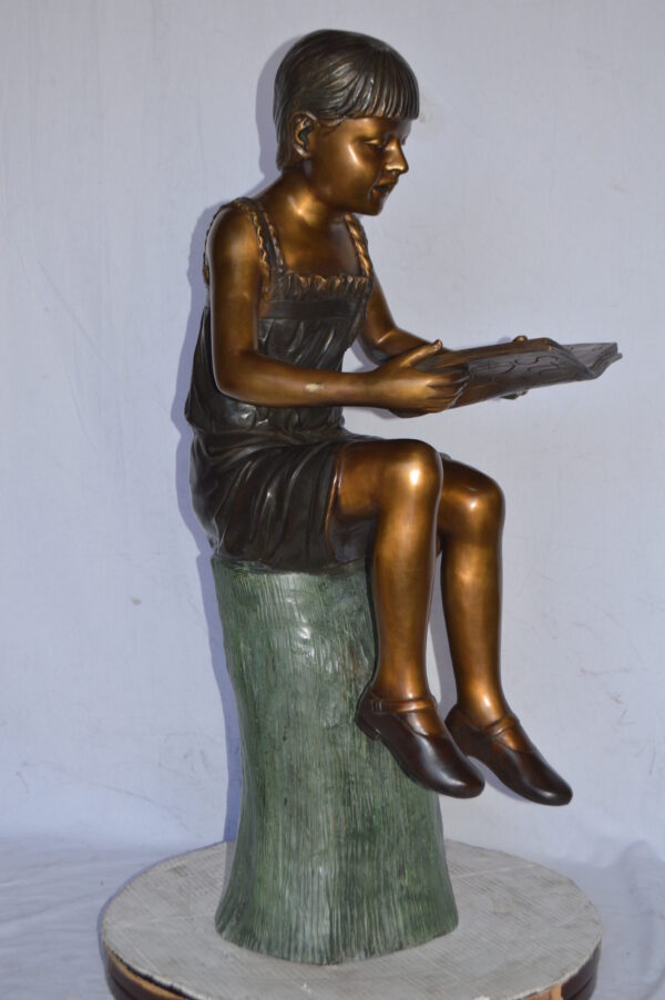 Girl Sitting on a Tree Stump, Reading Bronze Statue - Size: 15"L x 20"W x 22"H. - Image 10