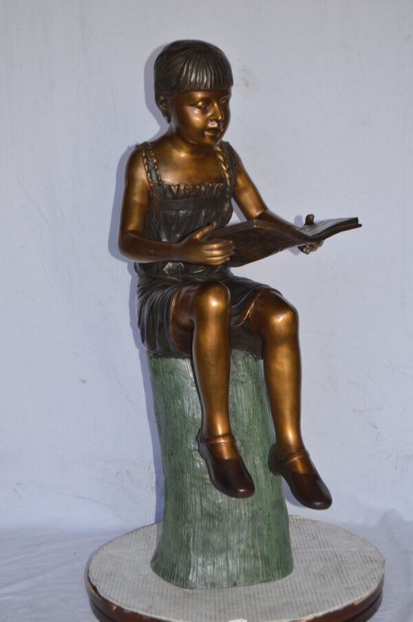 Girl Sitting on a Tree Stump, Reading Bronze Statue - Size: 15"L x 20"W x 22"H. - Image 11