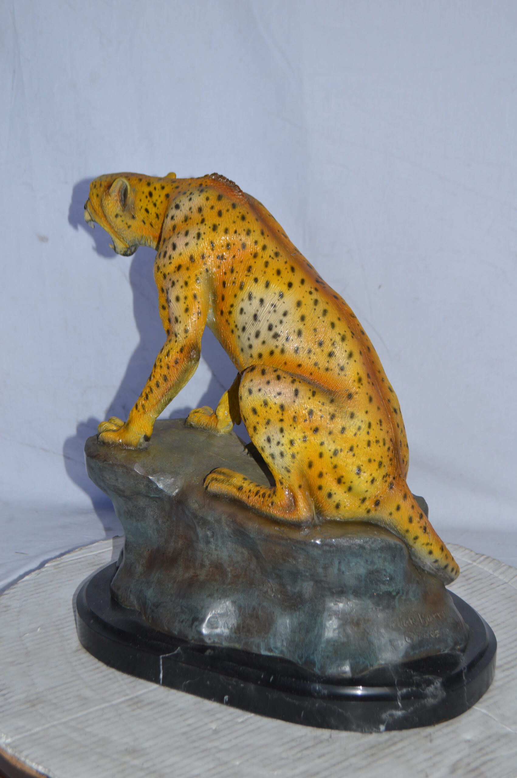 Cheetah sitting on a rock growling bronze statue - Size: 18L x 12W x  18H. - NiFAO