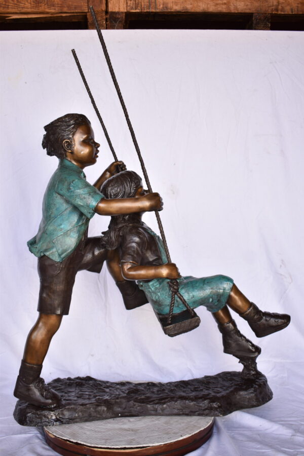 Boy and Girl Playing on a Swing bronze Statue - Size: 39"L x 17"W x 53"H. - Image 3