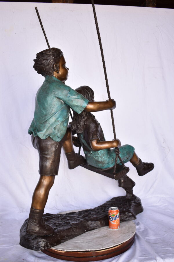 Boy and Girl Playing on a Swing bronze Statue - Size: 39"L x 17"W x 53"H. - Image 4