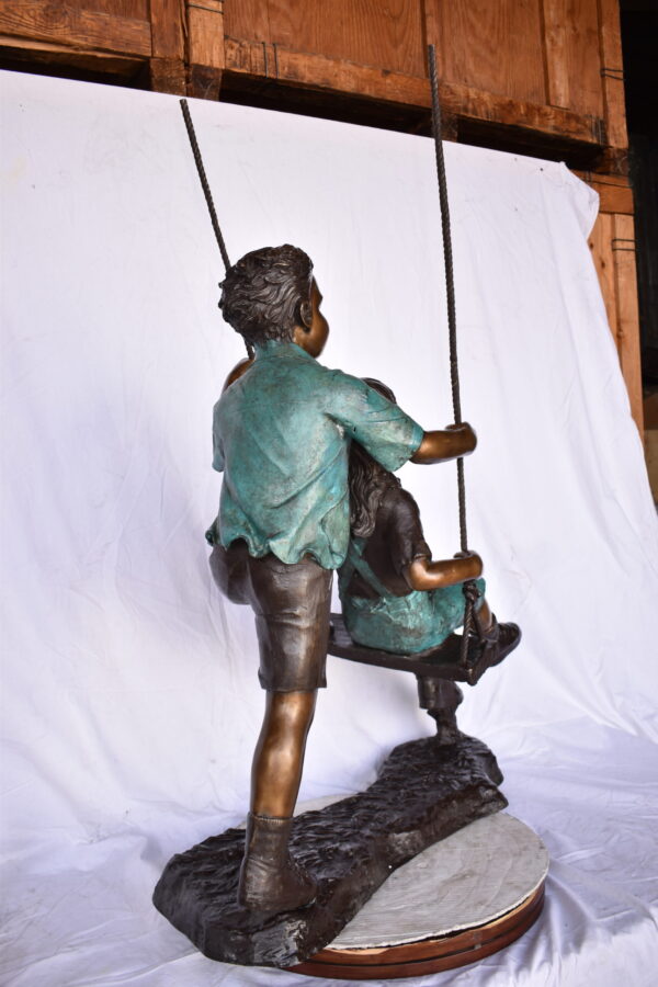Boy and Girl Playing on a Swing bronze Statue - Size: 39"L x 17"W x 53"H. - Image 5