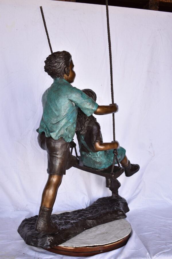 Boy and Girl Playing on a Swing bronze Statue - Size: 39"L x 17"W x 53"H. - Image 6
