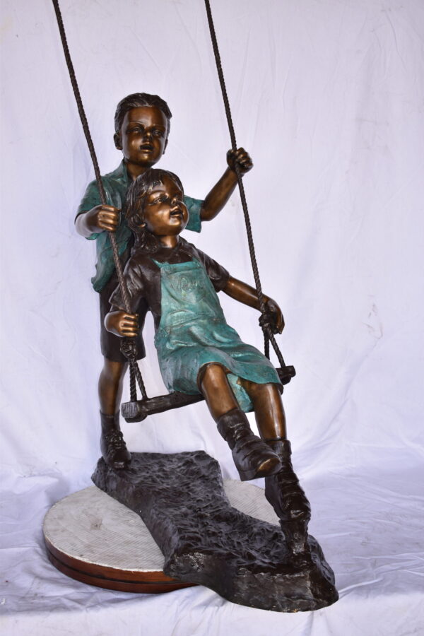 Boy and Girl Playing on a Swing bronze Statue - Size: 39"L x 17"W x 53"H. - Image 7