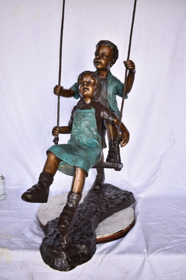 Boy and Girl Playing on a Swing bronze Statue - Size: 39"L x 17"W x 53"H. - Image 9