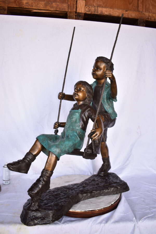 Boy and Girl Playing on a Swing bronze Statue - Size: 39"L x 17"W x 53"H. - Image 10