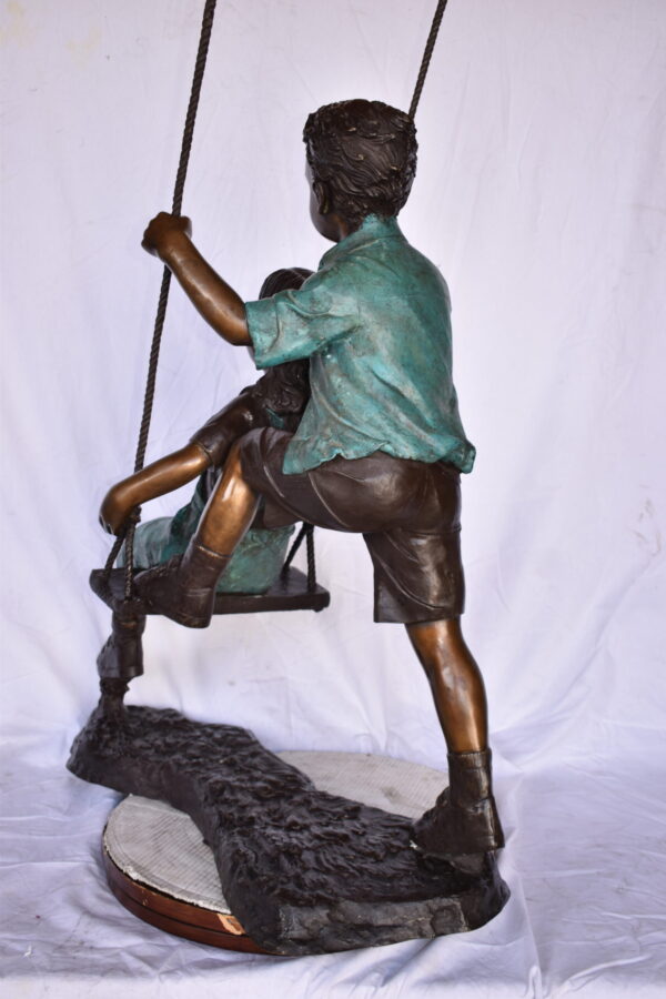 Boy and Girl Playing on a Swing bronze Statue - Size: 39"L x 17"W x 53"H. - Image 11