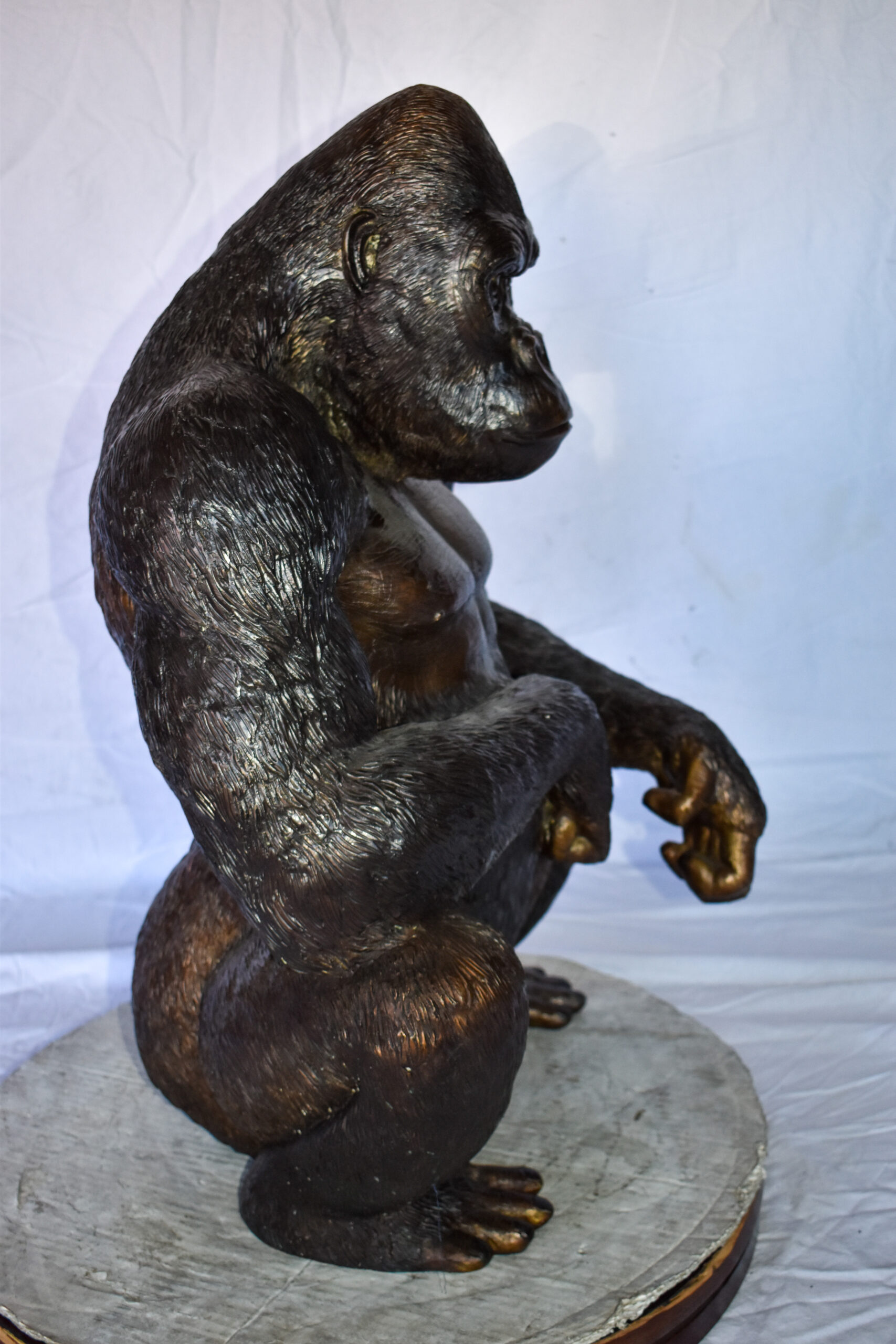 large bronze gorilla statue person sitting