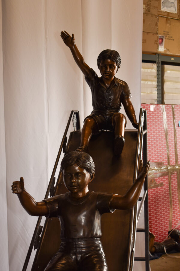 Lifsize Three kids playing on a slide bronze sculpture 114" x 18" x 83"H - Image 9
