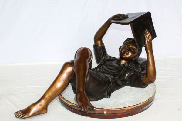 Boy Reading Bronze Statue with Book Raised Overhead 41" x 22" x 18"H - Image 3